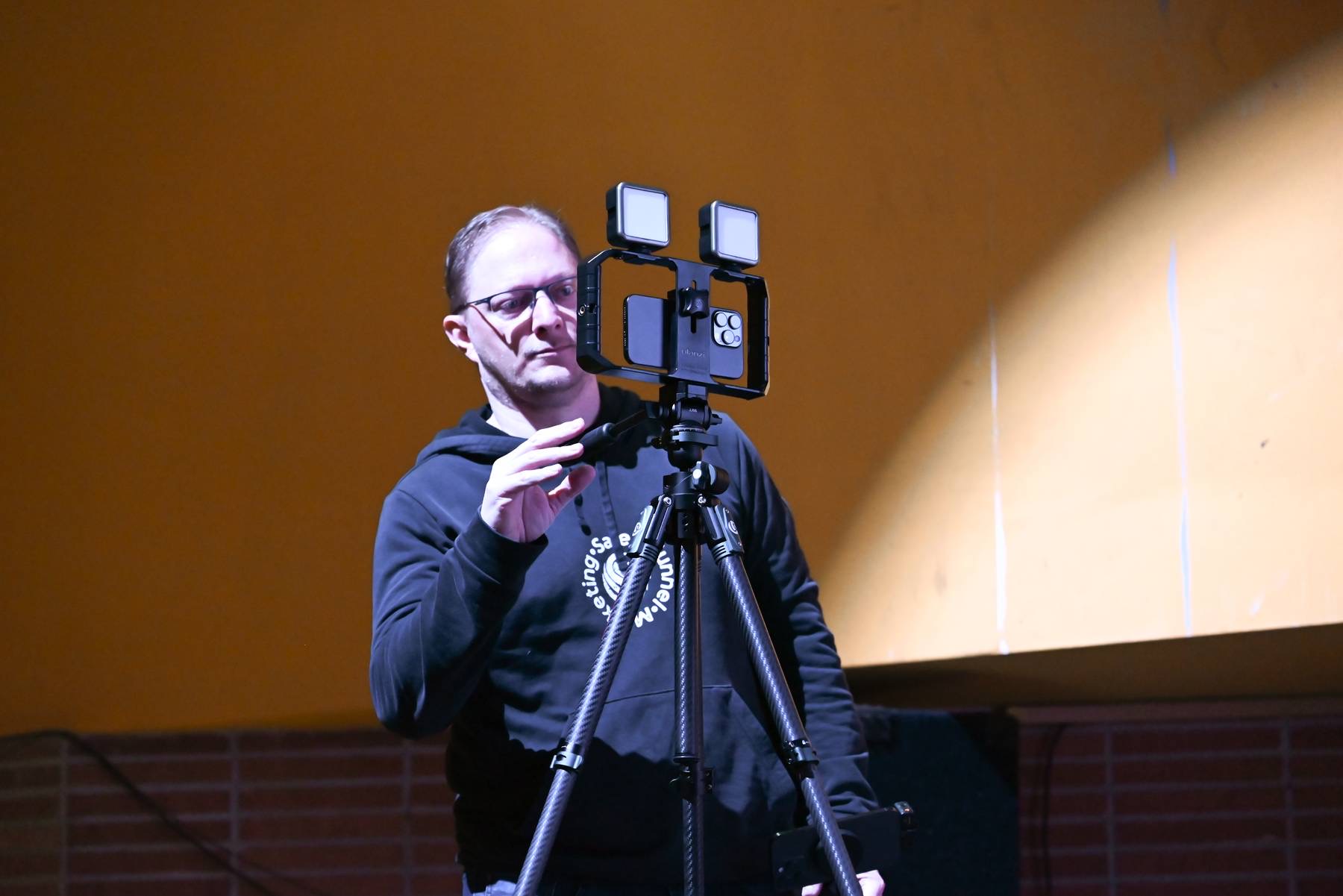 Jayson filming at a live event